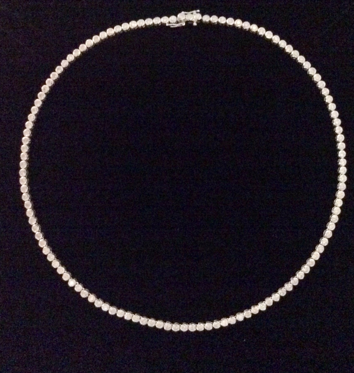 AN 18CT WHITE GOLD & DIAMOND TENNIS NECKLACE having a single line of round cut collet set