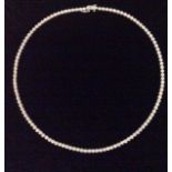 AN 18CT WHITE GOLD & DIAMOND TENNIS NECKLACE having a single line of round cut collet set