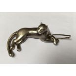 CARTIER, A SOLID SILVER DESK ORNAMENT IN THE FORM OF A RECLINING PANTHER Converted to a pendant,