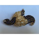 A HEAVY 18CT GOLD, SAPPHIRE AND DIAMOND ENCRUSTED BIRD FORM BROOCH The body of the bird is claw