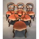 A SET OF SIX VICTORIAN MAHOGANY SPOON BACK DINING CHAIRS With carved and pierced rails and salmon