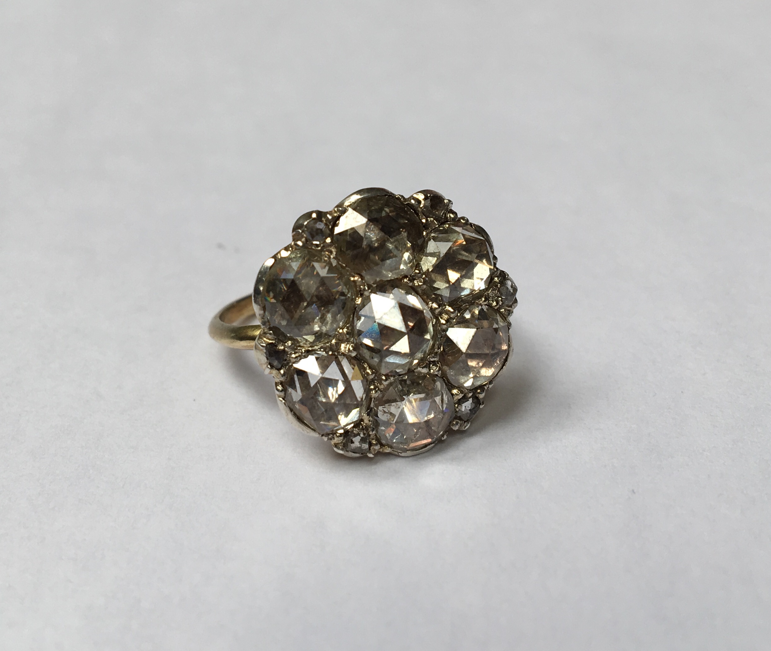 A 19TH CENTURY 14CT GOLD AND ROSE CUT DIAMOND CLUSTER DRESS RING The daisy cluster of seven foil