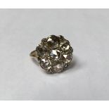 A 19TH CENTURY 14CT GOLD AND ROSE CUT DIAMOND CLUSTER DRESS RING The daisy cluster of seven foil