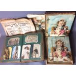 AN EARLY 20TH CENTURY POSTCARD ALBUM containing hand coloured photographic postcards of children and