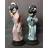 TWO 20TH CENTURY LLADRO PORCELAIN FIGURES A Geisha girl wearing a pink robe and hiding behind a fan,