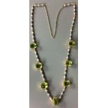 A LATE 19TH/EARLY 18TH CENTURY GOLD, PERIDOT AND SEED PEARL NECKLACE Having seven step cut peridots,