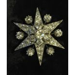 A VICTORIAN 14CT GOLD AND DIAMOND STARBURST BROOCH/PENDANT Set throughout with old and rose cut