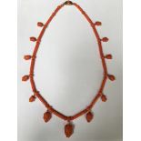 A VICTORIAN CORAL BEAD NECKLACE The alternating tubular and spherical coral beads suspended at