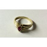 A HALLMARKED 9CT GOLD, RUBY AND DIAMOND DRESS RING The pear cut ruby claw set to a diamond