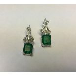 A PAIR OF EDWARDIAN STYLE PLATINUM, EMERALD AND DIAMOND DROP EARRINGS Emerald cut emeralds are