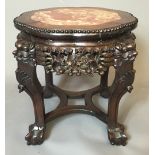 A 19TH CENTURY CHINESE HARDWOOD STAND Having a rogue marble inset top over an ornately carved apron,