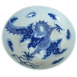 A CHINESE BLUE AND WHITE SHALLOW BOWL Decorated with a four toed dragon amongst clouds, Circa