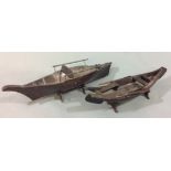 A RARE AND UNUSUAL PAIR OF 19TH CENTURY HARDWOOD MODEL ROWING BOATS With original display stands. (w