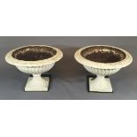 A PAIR OF NEOCLASSICAL STYLE CAST IRON CAMPANA URNS White painted with egg and dart borders over