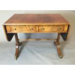 A REGENCY STYLE MAHOGANY SOFA TABLE Having two short drawers, raised on splayed legs joined by a