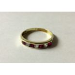 A 14CT GOLD, RUBY AND PASTE HALF HOOP RING Alternating square cut rubies and round cut white paste