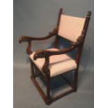 AN EARLY 20TH CENTURY MAHOGANY FRAMED OPEN ARMCHAIR With finials carved with facial masks above lion