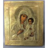 A 19TH CENTURY RUSSIAN ICON OIL ON PANEL Madonna and child, with brass okland engraved with a