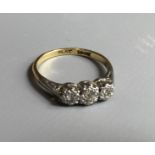 AN 18CT GOLD, PLATINUM AND DIAMOND SET THREE STONE RING (Size K/L).