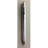 SHEAFFER, A VINTAGE BRUSHED STEEL BALLPOINT PEN Of simple design with a polished steel trim. (approx