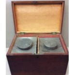 A LARGE VICTORIAN MAHOGANY AND BRASS TEA CADDY Having two lead canisters with circular lids, held in