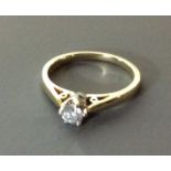 A 9CT GOLD AND DIAMOND SOLITAIRE RING Having a single round cut diamond held in a plain gold