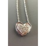 A 9CT WHITE GOLD AND DIAMOND PENDANT The heart shape pendant having pave set diamonds, suspended