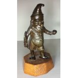 'MR PUNCH', AN EDWARDIAN BRONZE CIGARETTE LIGHTER Carrying a feather and inkwell, with a hole to