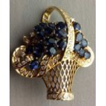 A VINTAGE 18CT GOLD, SAPPHIRE AND DIAMOND BROOCH The pierced basket mount set with multi diamonds,