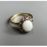 A VINTAGE 9CT GOLD DIAMOND, OPAL AND RUBY SET RING The cabochon cut opal surrounded by diamonds