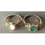 A 9CT GOLD, OPAL AND DIAMOND RING The cabochon cut opal flanked by two sets of three emeralds,