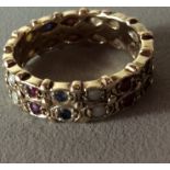 A VINTAGE 9CT GOLD, RUBY, OPAL AND SAPPHIRE ETERNITY RING Two rows of stones held in a scalloped