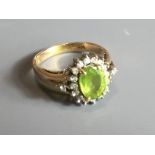 A VINTAGE 14CT GOLD, PERIDOT AND DIAMOND RING With central stone flanked by eighteen diamonds (