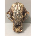 A LATE 19TH/EARLY 20TH CENTURY DAYAK TRIBE CARVED SUN BEAR SKULL