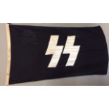 A WORLD WAR II GERMAN SS FLAG Black ground with white lettering to centre and skull and cross bones,