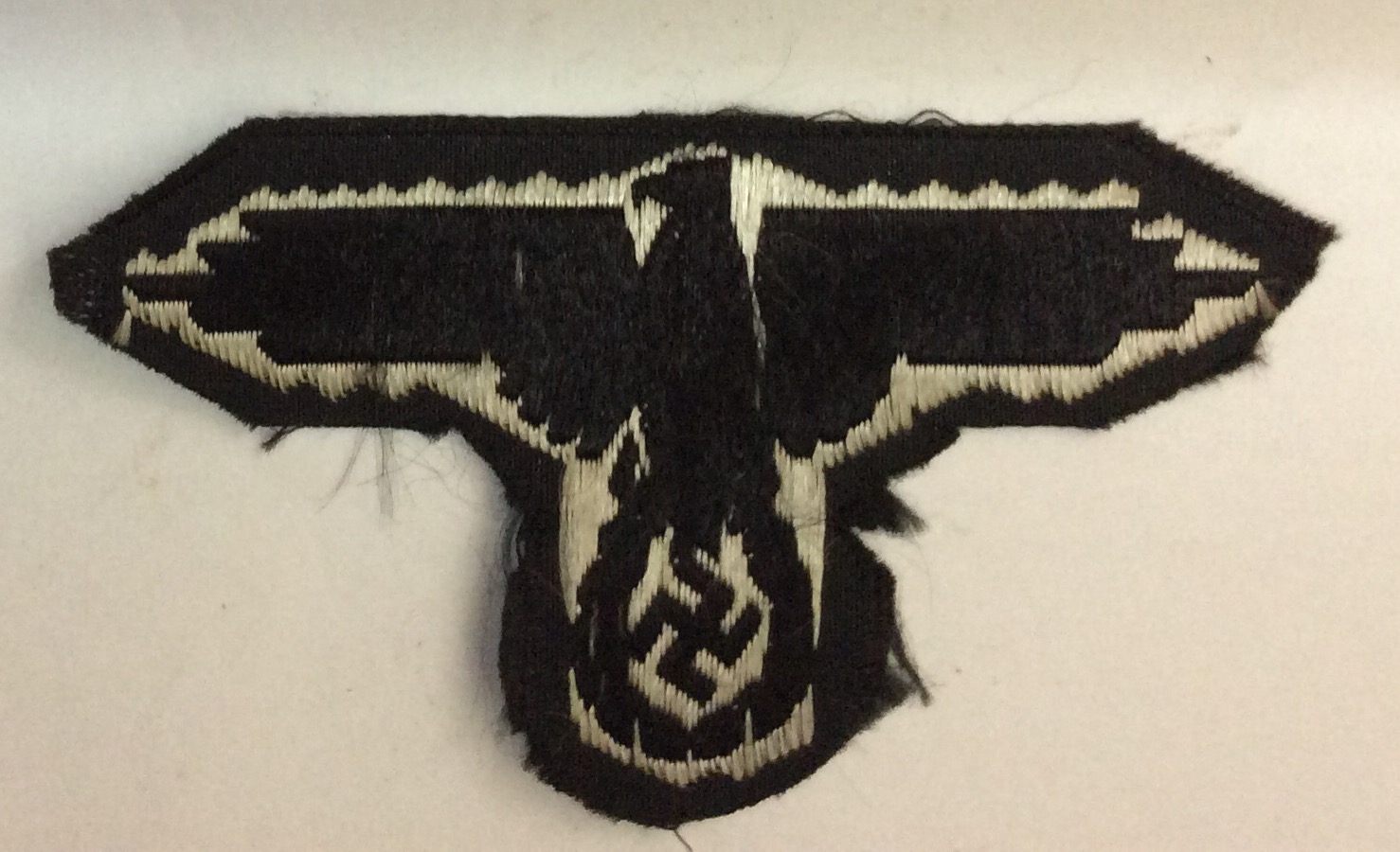 A WORLD WAR II GERMAN SS ARM BADGE Having the German eagle on a black rayon fabric ground. - Image 3 of 4