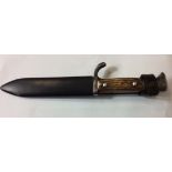 AN EARLY 20TH CENTURY GERMAN HITLER YOUTH KNIFE Stag horn grip with black scabbard and leather grip,