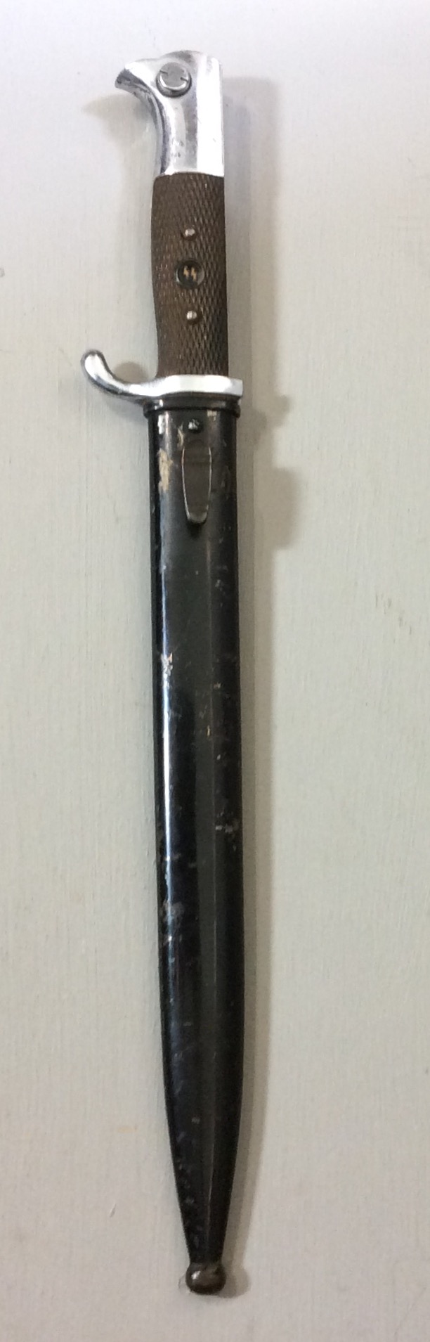 A WORLD WAR II GERMAN SS DRESS BAYONET The handle fitted with a period roundel badge and black