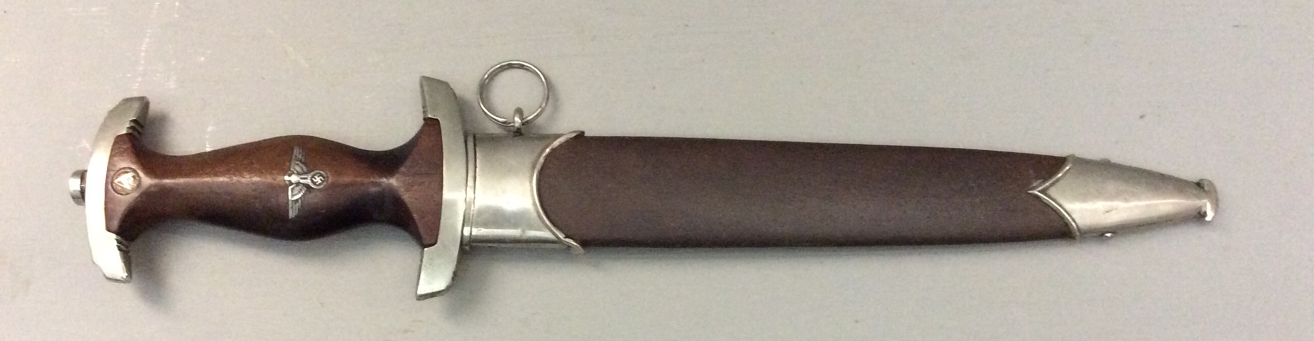 A WORLD WAR II GERMAN SA DAGGER Brown wooden grip with solid nickel fittings and brown leather