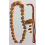 A VINTAGE AMBER AND CRYSTAL SET NECKLACE The graduating elliptical beads interspersed with crystal