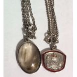 A VINTAGE SILVER OVAL MOURNING LOCKET/PENDANT The central panel set with hair and suspended on a