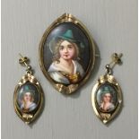 A 19TH CENTURY CONTINENTAL YELLOW METAL OVAL MOURNING BROOCH With a painted depiction of a child,