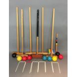 A VINTAGE CROQUET SET Comprising six croquet mallets, seven balls and six iron hoops.