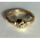AN UNUSUAL 18CT GOLD AND DIAMOND SOLITAIRE RING Having a single oval cut diamond collet set on a