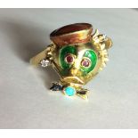 A RARE AND UNUSUAL 18CT GOLD DIAMOND, RUBY AND ENAMEL RING Handmade to represent the character