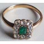 AN EDWARDIAN 18CT GOLD AND EMERALD RING The octagonal step cut emerald surrounded by ten round cut