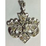 A CONTINENTAL WHITE METAL AND FANCY DIAMOND PENDANT DROP The interlocking leaf design set with