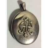 A VICTORIAN WHITE METAL OVAL LOCKET Of plain form, bearing the initials 'EMI'. (approx 4cm x 5cm)