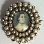 AN 18TH CENTURY YELLOW METAL, IVORY AND SPLIT PEARL MINIATURE PORTRAIT BROOCH The central panel