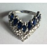 A VINTAGE 18CT WHITE GOLD, DIAMOND AND SAPPHIRE WISHBONE RING Having a row of oval cut sapphires